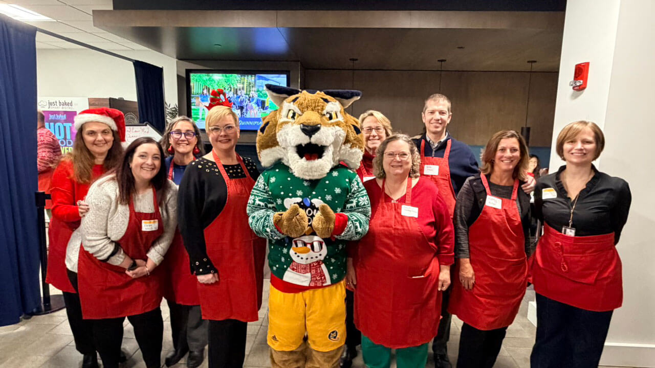 Faculty and Staff pose with boomer