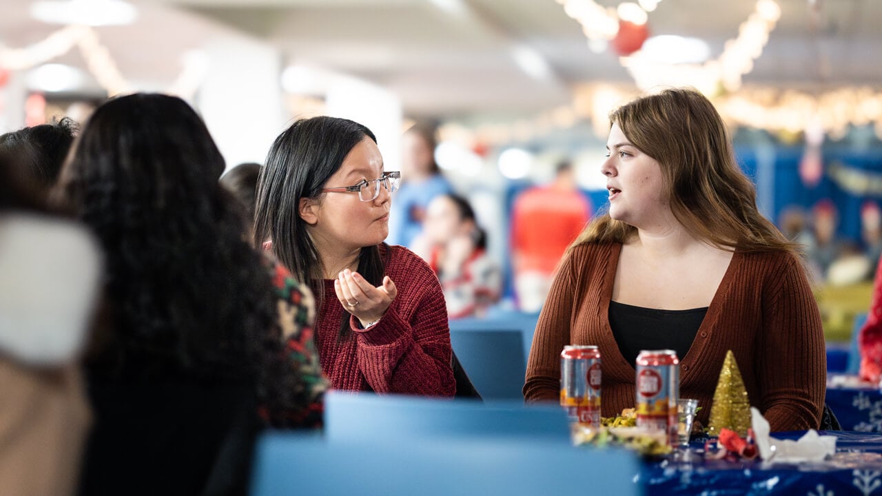 Two people talking at a table