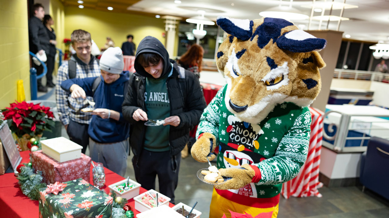 Boomer makes holiday cookies alongside students