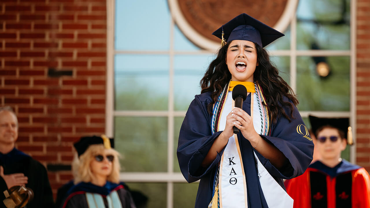 Sorority member sings at Graduation