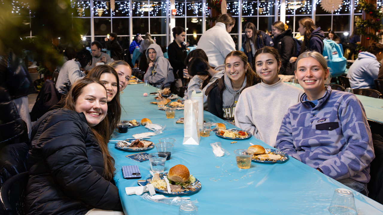Students enjoy a festive holiday dinner in the holiday decorated dining hall