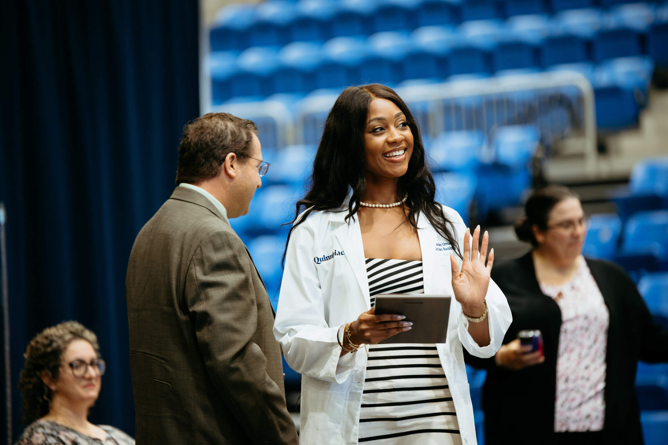 Alumna Stephanie Umeugo receives her white coat at the White Coat Certificate Ceremony.