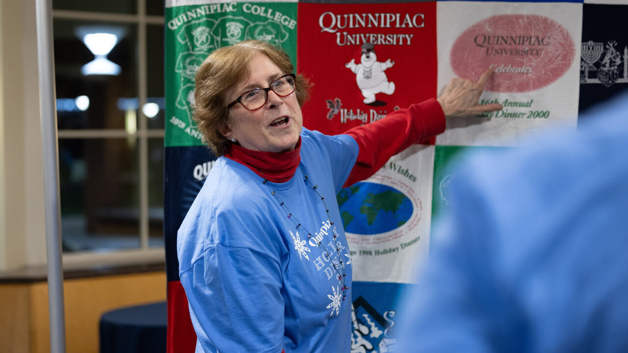 Jill Martin points at t-shirt quilt