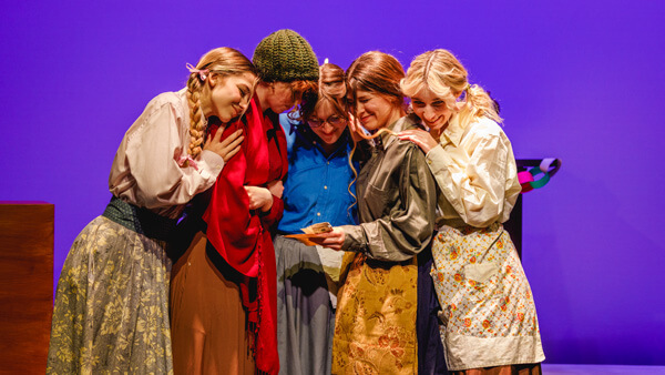 5 students hugging in character for Little Women