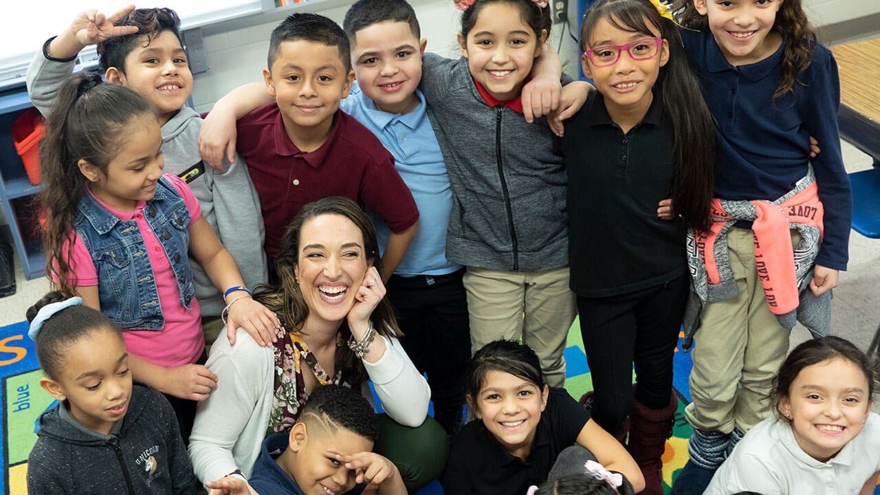 Teacher surrounded by students