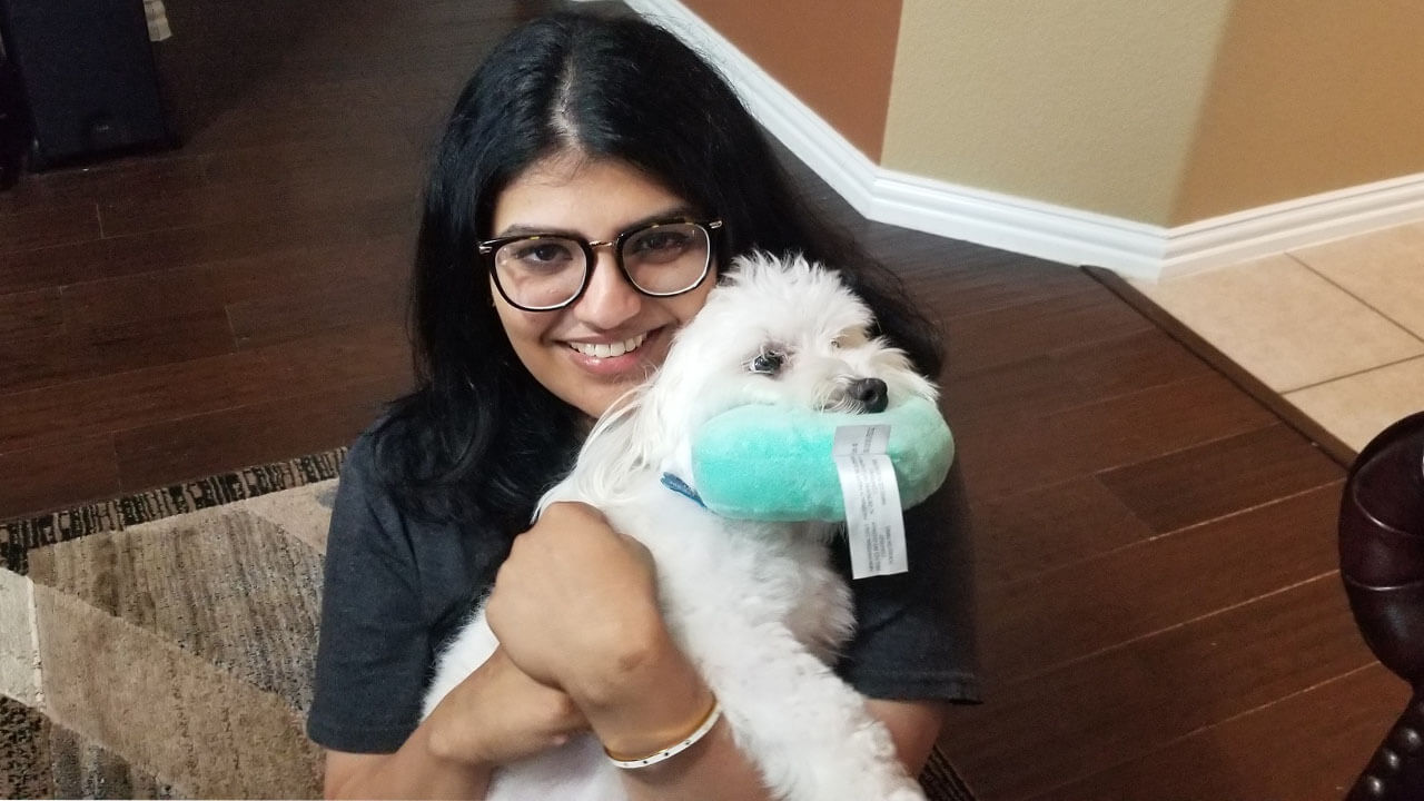 woman holding a white dog