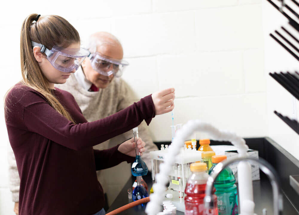 Pre-dental studies student and professor perform lab procedures