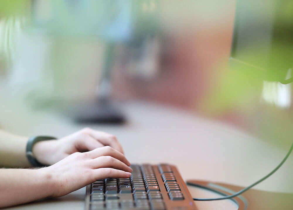 Closeup shot of a pair of hands typing on a keyboard