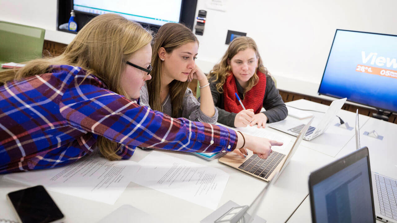 Kiley Andrews ’18, Sydney Kenyon ’19, and Cara O’Meally ’19, all Biomedical Marketing students, working during class.