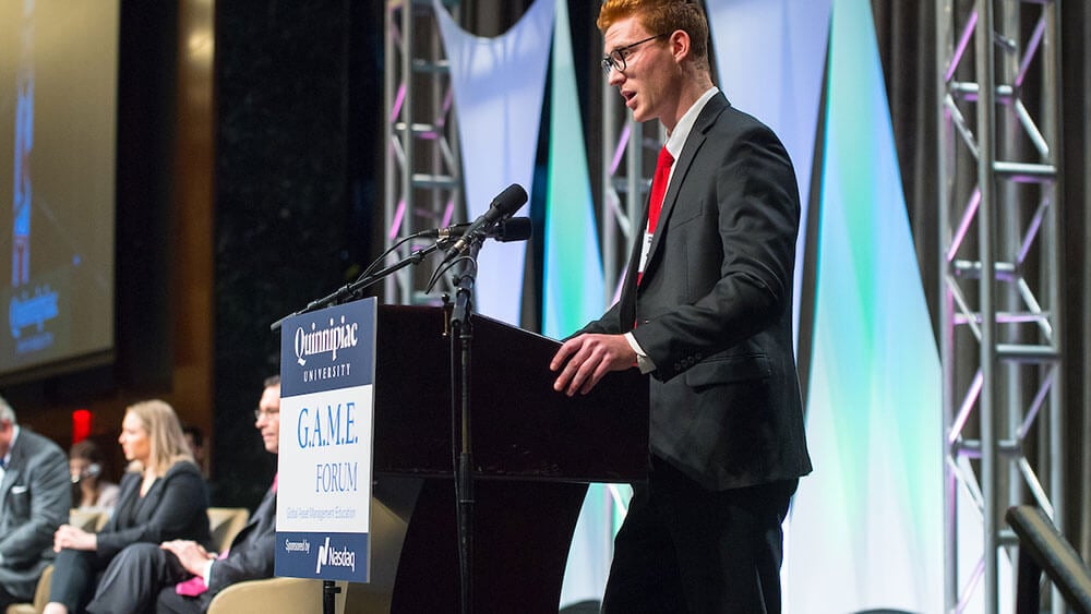 A student speaks at the podium at the GAME Forum in Manhattan