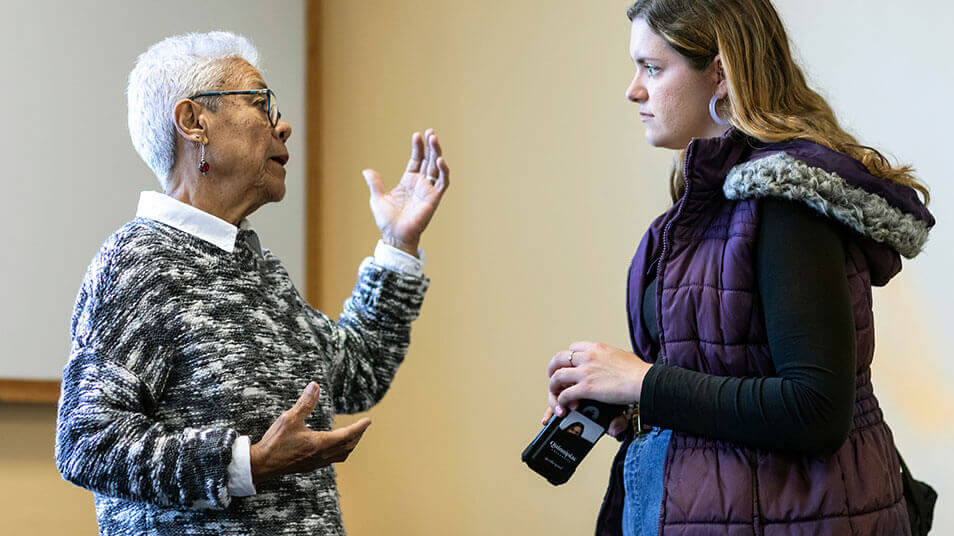 A communications student interviews the director of a food bank for a podcast episode