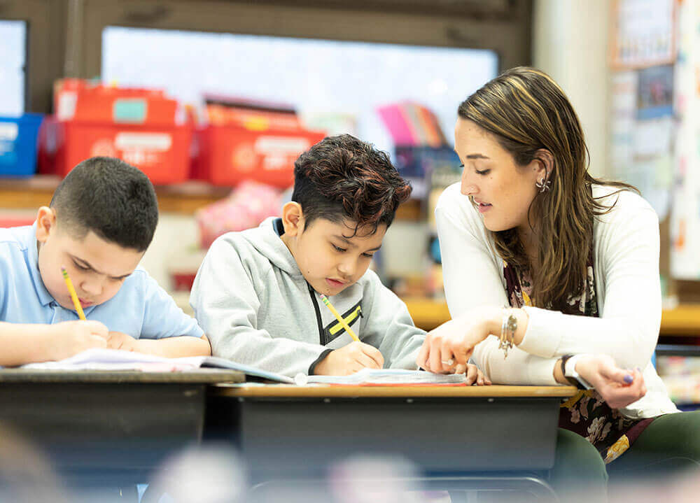 School of Education alumna Erin Westerman teaches two third-graders fractions in her classroom in Connecticut