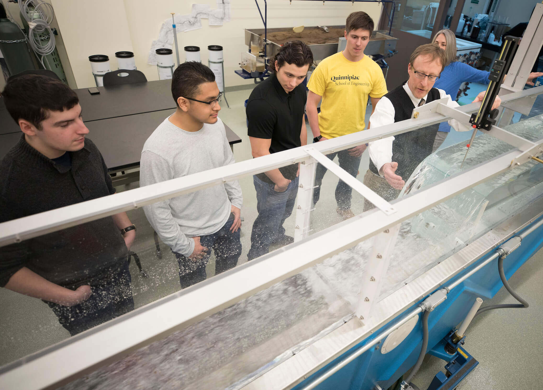 Students watch the professor teach in a lab room on campus