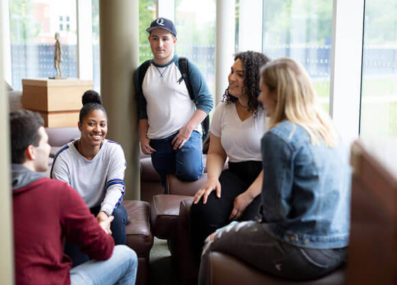 Five students working together in the library.