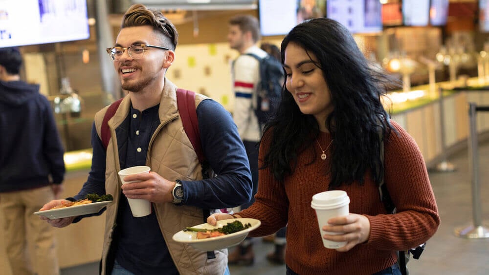 From left, orientation leaders Kyle Lopez '19, mechanical engineering, and Zurama Rodriguez '19, behavioral neuroscience, get lunch together in the dining hall of Quinnipiac University's Carl Hansen Student Center at the Mount Carmel Campus