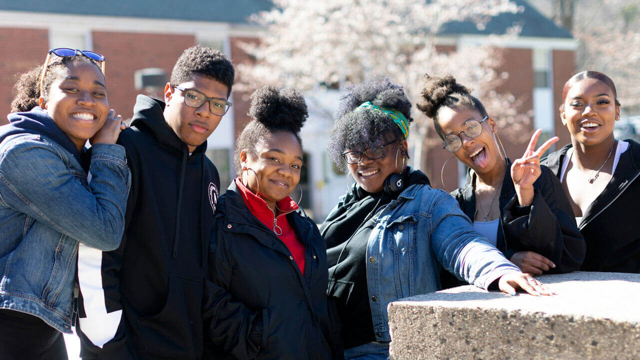 A group of students smiling while attending the Multicultural Carnival on Mount Carmel Campus