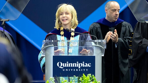 President Judy Olian speaks at a podium