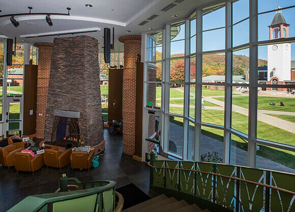 Students sit near a fire place