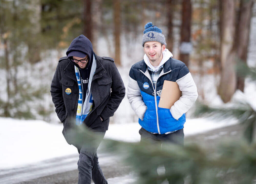 Two male students walking in the street for campaign