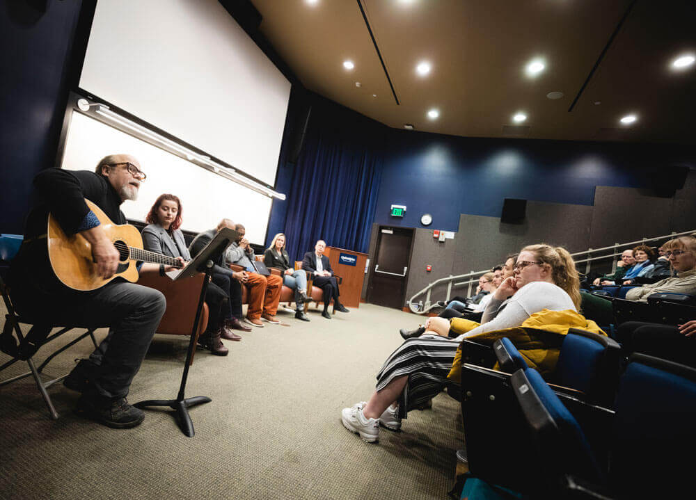 Photo of panel in front of audience