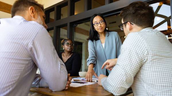 Individuals having a meeting in a conference room