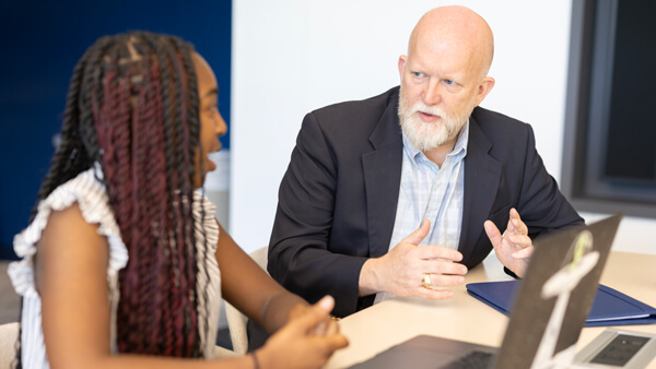 Faculty member talking with a student