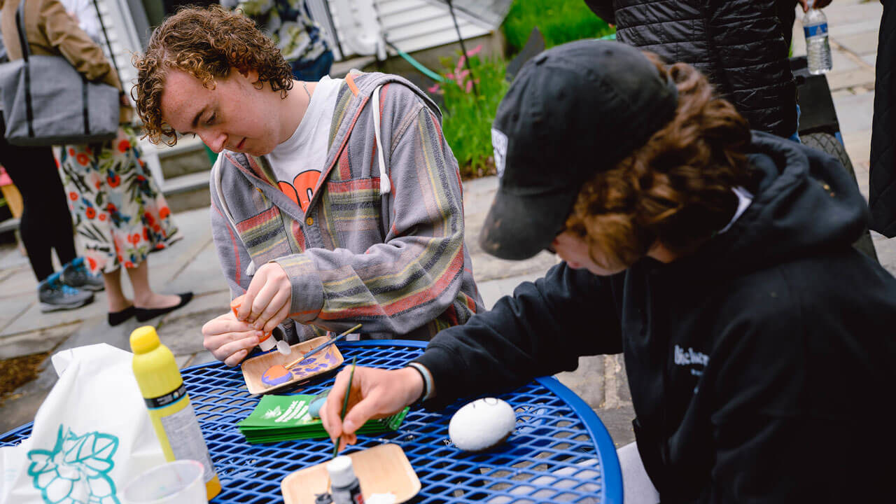 Students painting on rocks