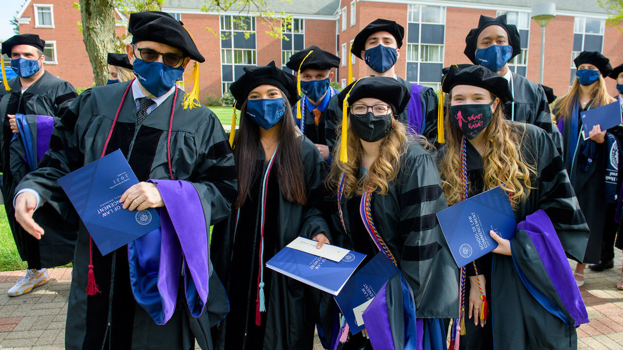 A half dozen graduates pose for a photo as they walk in to the ceremony