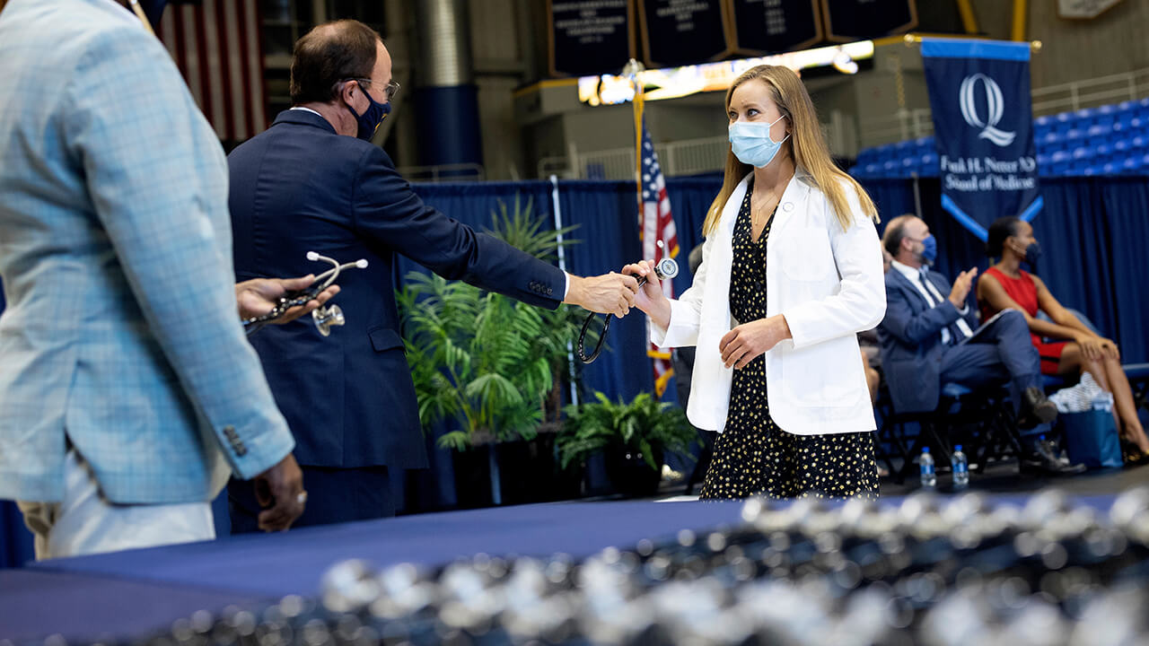 Student receives stethoscope.