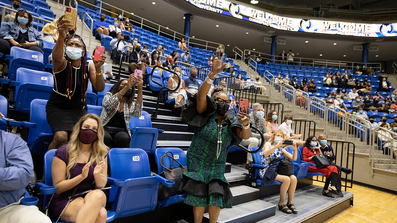 Friends and family wave to students.