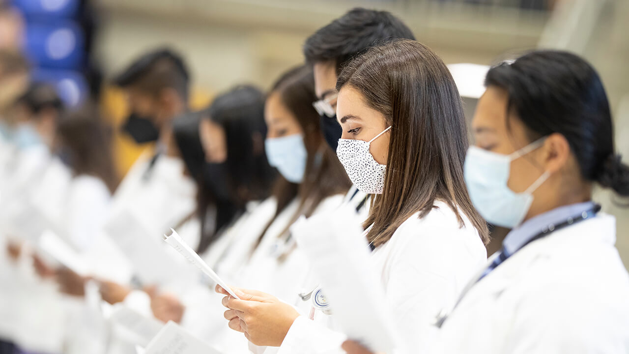 Students read an oath.