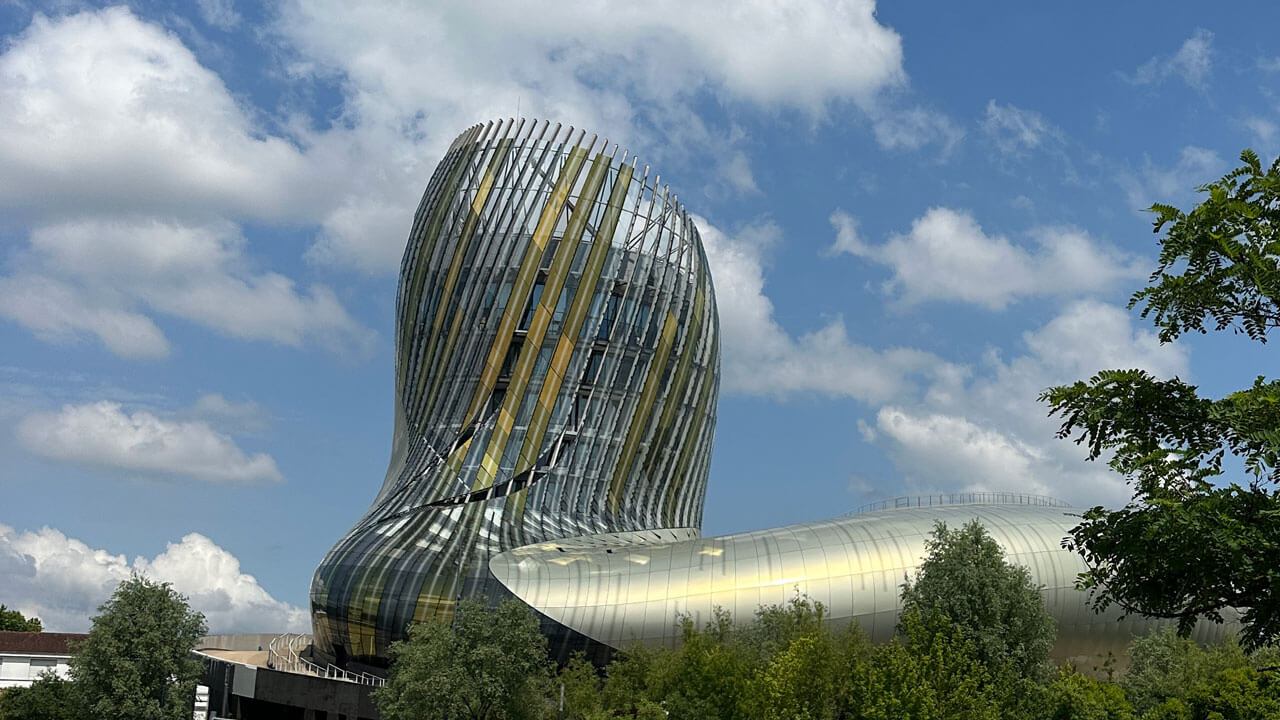 Large modern structure in the background of a blue sky, La Cite du Vin