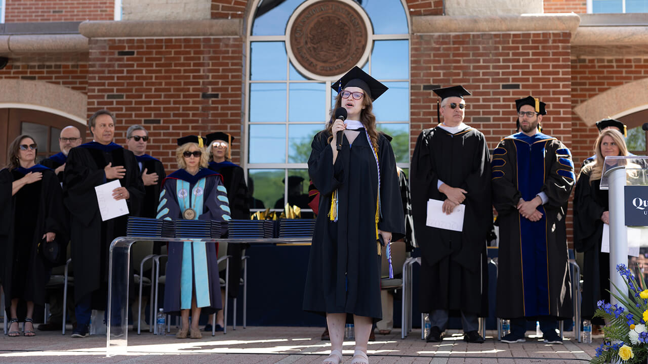 National anthem is sung by a graduate on stage