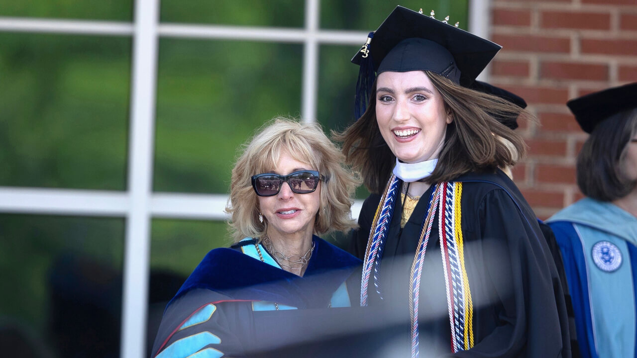 President Olian poses for a photo with graduate Mel Careri