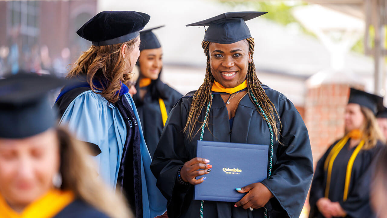 Graduate smiles with her diploma