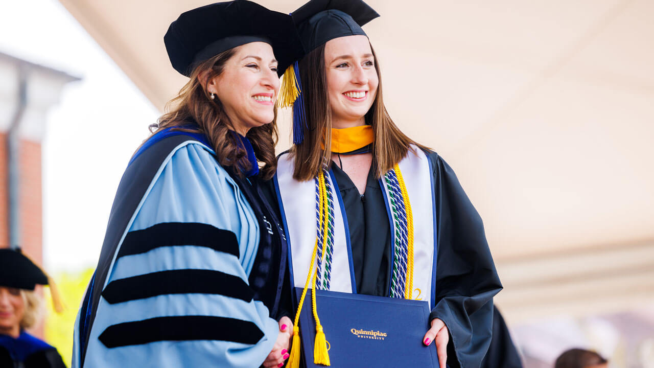 Dean Holly Raider hugging student during celebration of graduation