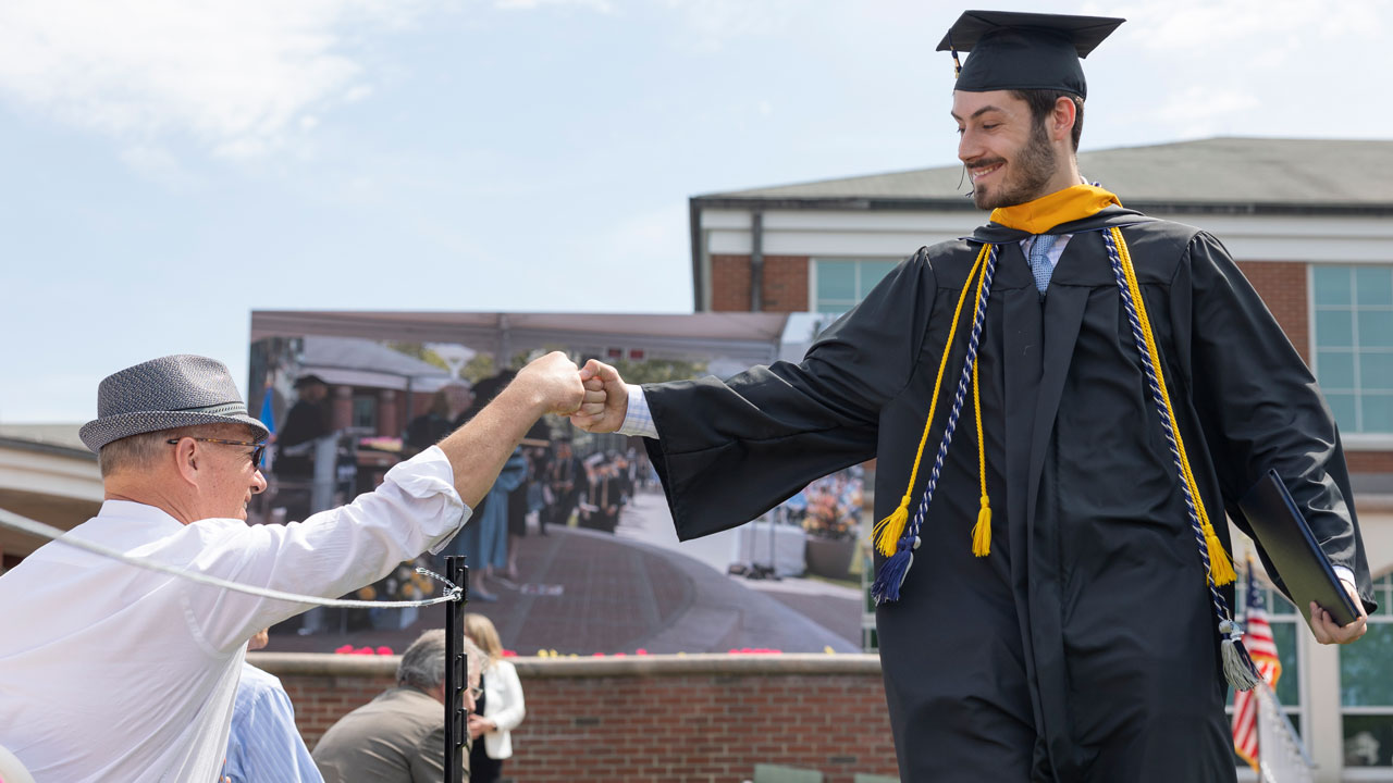 SOB Graduate fist pumps with parent