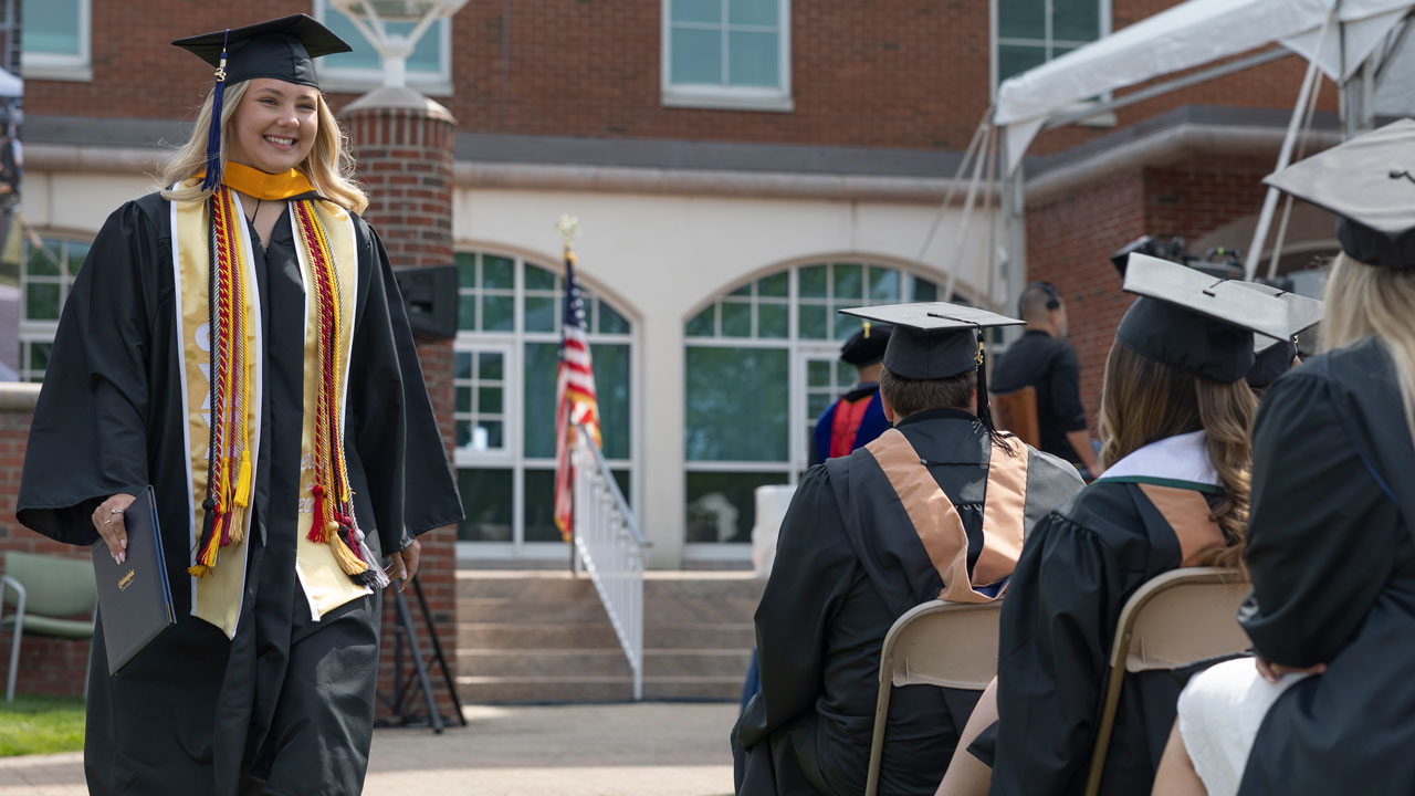 SOB graduate walks and smiles