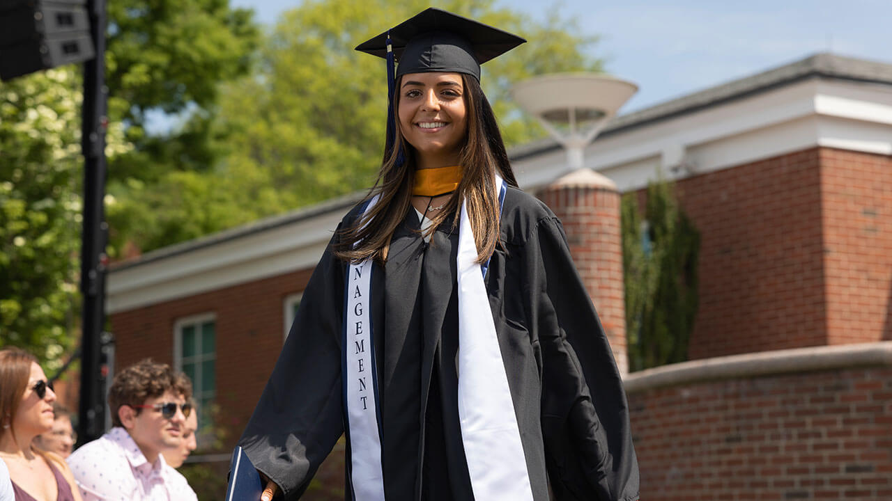 Student smiling in her cap and gown