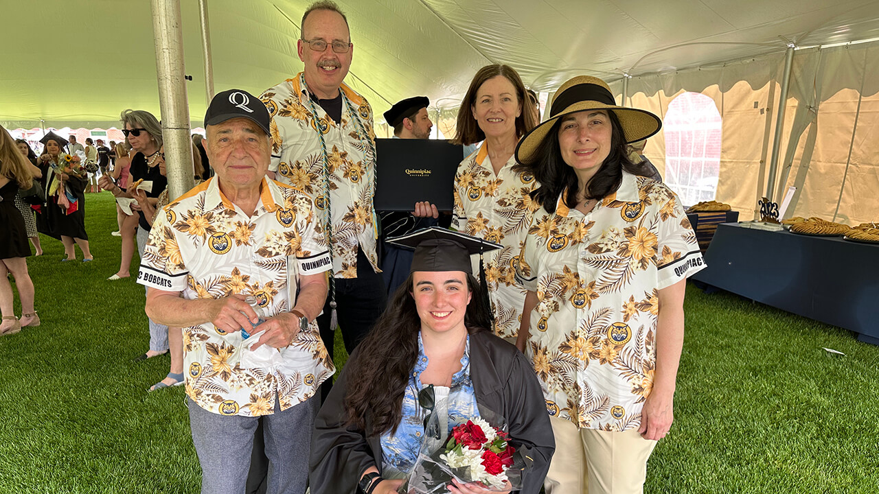 Spirited family wears Quinnipiac shirts with their graduate