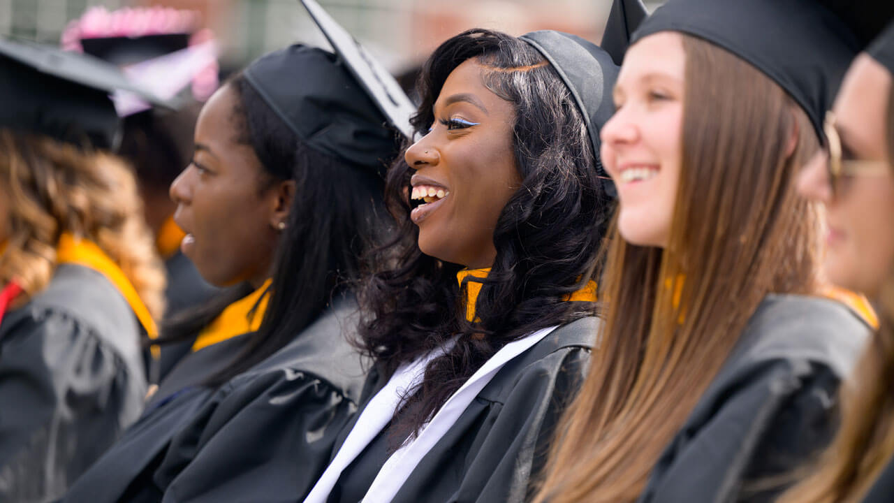 Graduates delightfully smiling during commencement