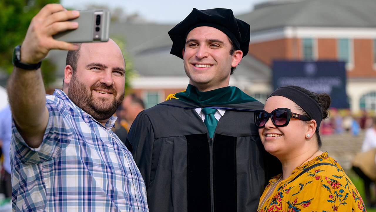 Family takes a selfie with graduate