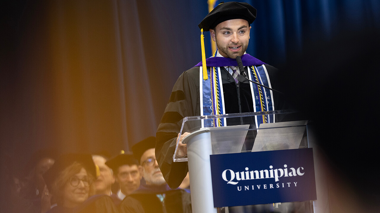 Graduate addresses their fellow classmates at the podium