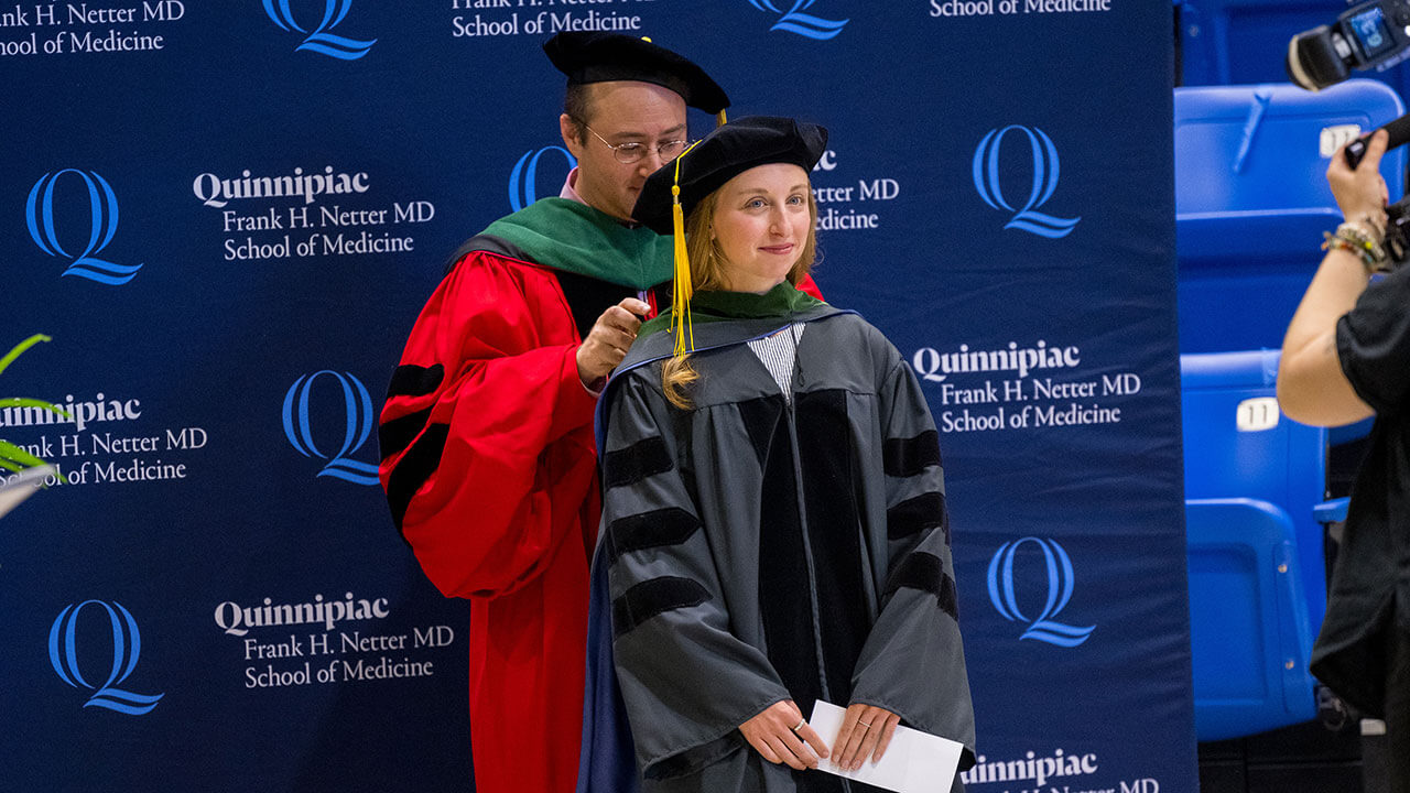 Woman med grad student being hooded