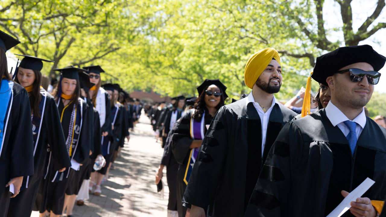 Graduates formed in a line happy to walk in commencement