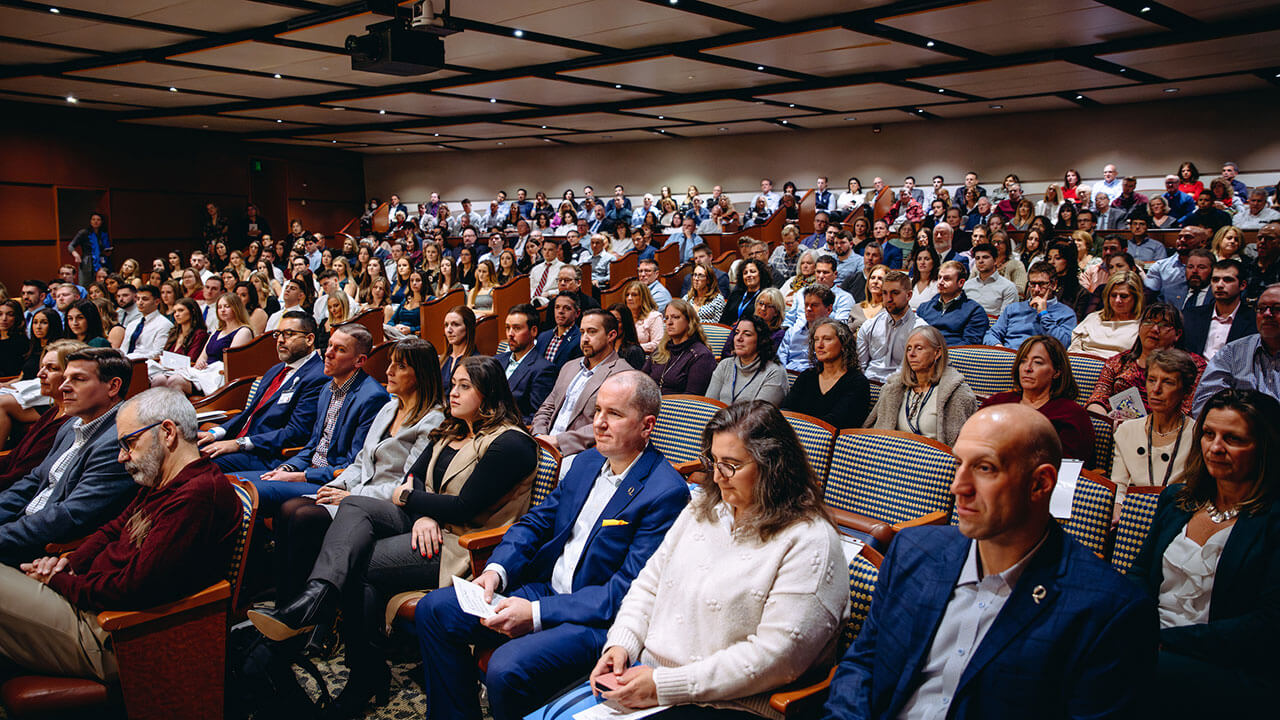 The full room at the DPT white coat ceremony. Everyone is seated and paying attention.