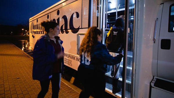 Students going on the shuttle at night