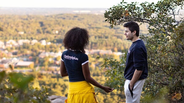 Students talking after hiking the giant with a view of the Mount Carmel Campus