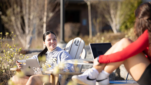 Students sitting at the ampitheater with their laptops open