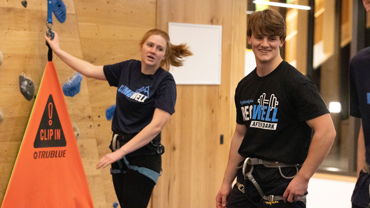 Students get ready to rock climb during rec and wellness opening.